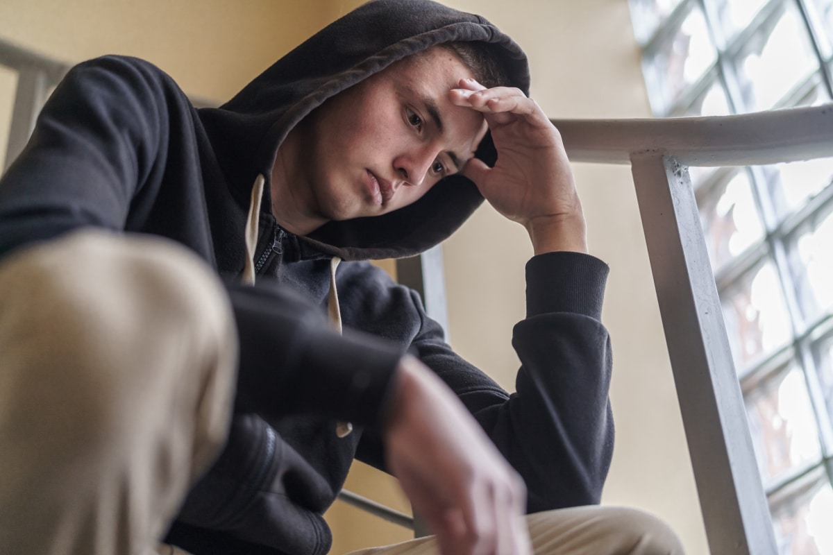 Young man in a hood looking worried